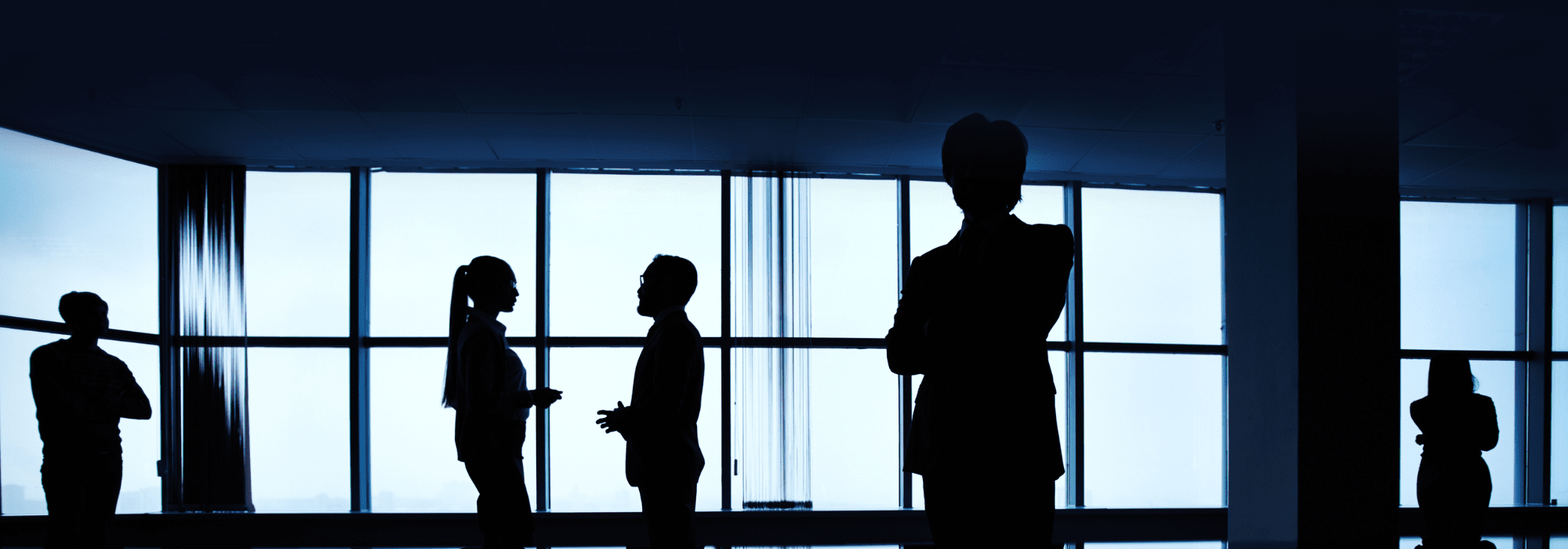 People in a meeting room discussing executive search strategies at Worldwiders, a global recruitment agency specializing in leadership roles.